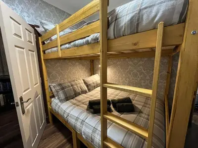 a couple of bunk beds in a room at The Nook Crieff - central 2-bed with garden :) in Crieff
