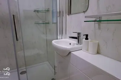 a white bathroom with a sink and a shower at The Wee Nook Crieff - 1-bed with garden :) in Crieff