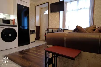 a living room with a couch and a table in a room at The Wee Nook Crieff - 1-bed with garden :) in Crieff