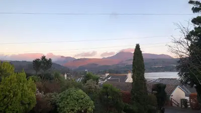a view of a town with mountains in the background at Belvedere in Brodick