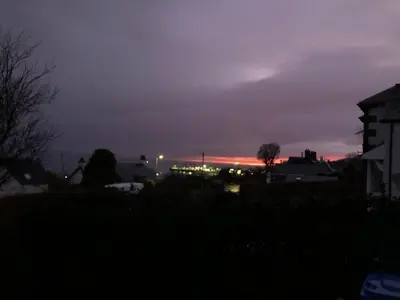 a view of a sunset from a city at night at Belvedere in Brodick