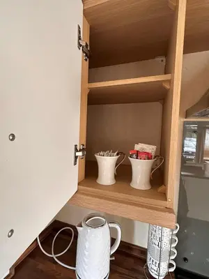 a cupboard with two mugs sitting on it at Swift Moselle 2 Bedroom Caravan Located in Uddingston, Glasgow at Maryville Caravan Site in Uddingston