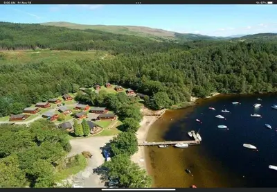 an aerial view of a lake with boats on it at Cozy Loch Lomond Lodge 27, Rowardennan in Rowardennan