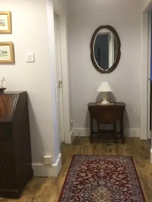 a hallway with a table and a mirror on the wall at Chapelhill Hideaway Isle of Bute licence AR00654F in Rothesay