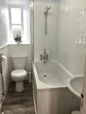 a bathroom with a tub and a toilet and a sink at Chapelhill Hideaway Isle of Bute licence AR00654F in Rothesay