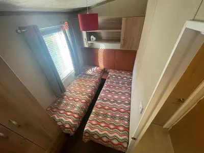 a small room with a bed in a tiny house at Silver Birch Lodge in Auchterarder