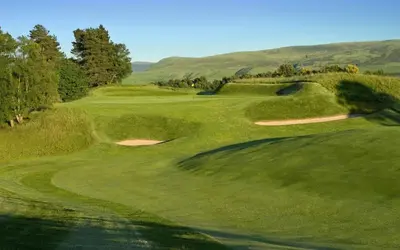 a view of a golf course with a green at Silver Birch Lodge in Auchterarder
