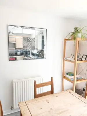 a dining room with a table and a mirror at Urban Escape Glasgow Green Free Parking 20min walk to City Center in Glasgow