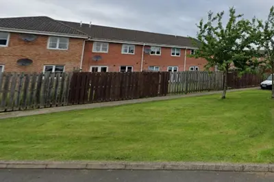 a wooden fence in front of a house at Urban Escape Glasgow Green Free Parking 20min walk to City Center in Glasgow