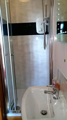 a bathroom with a sink and a shower at Knight's Rest Guest House in Airdrie