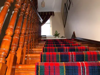 a row of stairs in a church with colorful seats at Knight's Rest Guest House in Airdrie