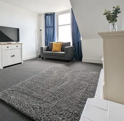 a living room with a couch and a television at Campbeltown Loch in Campbeltown
