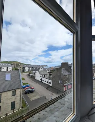 a view from a window of a city street at Campbeltown Loch in Campbeltown