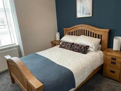 a bedroom with a bed with two pillows on it at 34 James St cosy 2 bedroom, ground floor apartment, garden in Helensburgh