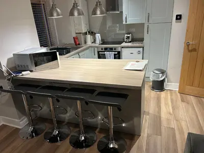 a kitchen with a counter with a laptop on it at 34 James St cosy 2 bedroom, ground floor apartment, garden in Helensburgh
