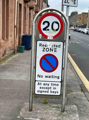 a street sign on the side of a street at 34 James St cosy 2 bedroom, ground floor apartment, garden in Helensburgh