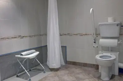 a bathroom with a toilet and a shower at The Winnock Hotel in Drymen
