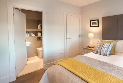 a bedroom with a bed and a bathroom at Corriedow in Thornhill