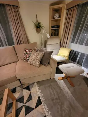 a living room with a couch and a chair at FAB Caravan Holiday Home in Colmonell