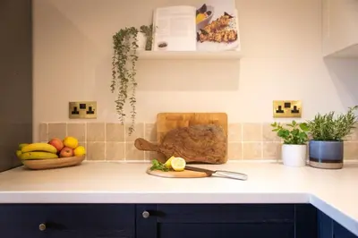 a kitchen counter with fruits and vegetables on it at Stunning 2 bed flat with parking, and garden with mountain views in Crieff