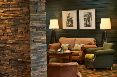 a living room with a couch and two chairs and a table at Isle Of Mull Hotel and Spa in Craignure
