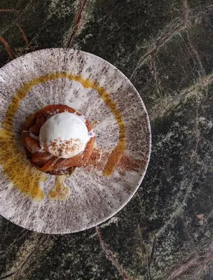 a piece of food on a plate on the ground at Isle Of Mull Hotel and Spa in Craignure