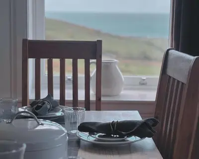 a table with a plate of food on top of it at Honeysuckle Cottage in Killean