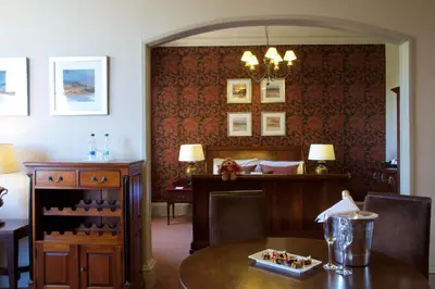 a dining room with a table and a desk at Stonefield Castle Hotel ‘A Bespoke Hotel’ in Stonefield