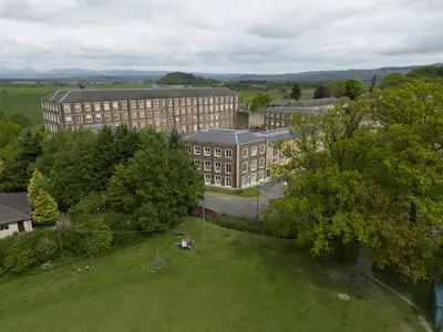 an overhead view of a building with a green field at Mhuilinn Apartment in Stirling