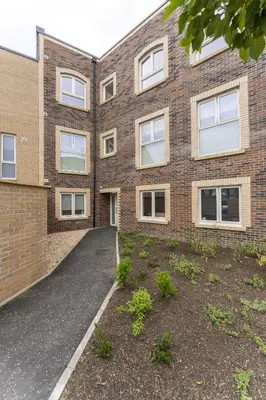 an external view of a brick building with a driveway at Mhuilinn Apartment in Stirling