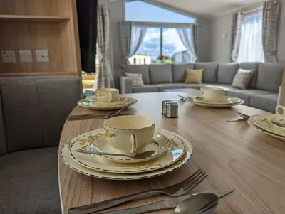 a table with plates and silverware on top of it at The Castleton 20 in Ardentinny