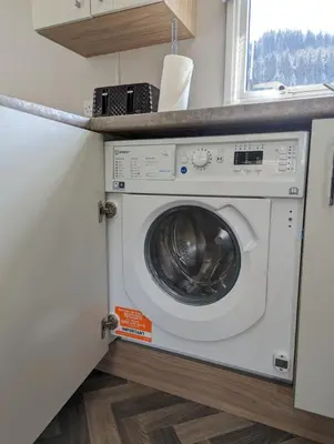 a washing machine in a kitchen with a counter at The Castleton 20 in Ardentinny
