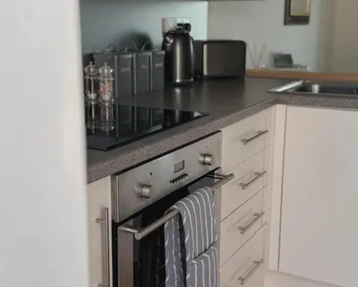 a kitchen with an oven with a towel on it at Primrose Cottage in Killean