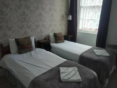a hotel room with two beds with towels on them at Glasgow city Charlotte service Aparments in Glasgow