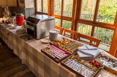a table with a buffet with food on it at Oak Tree Inn in Balmaha