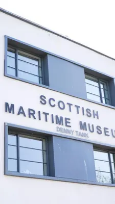 an office building with a sign for a scottish mariculture museum at Meadow Apartment in Dumbarton