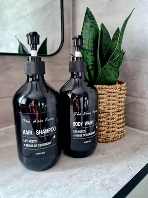 two bottles of hair shampoo sitting on a counter with a plant at Spacious 5bed house, FREE parking, NO PARTY ! in Glasgow