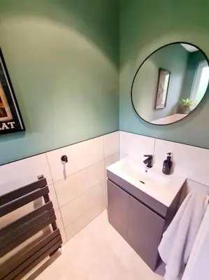 a bathroom with a sink and a mirror at Spacious 5bed house, FREE parking, NO PARTY ! in Glasgow