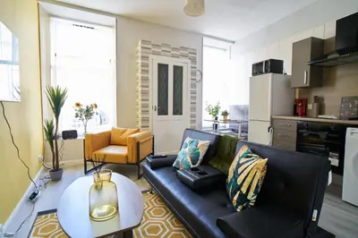 a living room with a couch and a table at 1 BDR Apt By Caledonia Luxe Stays Short Lets & Serviced Accommodation Lanark in Douglas