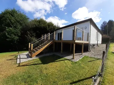 a tiny house with a staircase in a yard at Highland Haven, Glencoe in Ballachulish