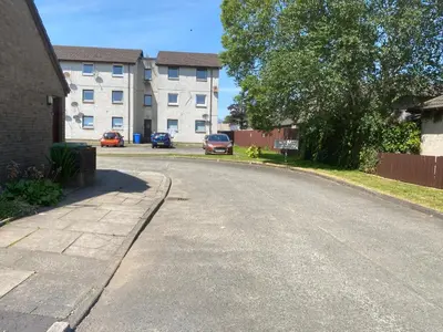 an empty street in front of a building at Argyll Apartment Loch Lomond in Balloch