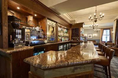 a bar with a marble counter in a room at Oban Bay Hotel in Oban