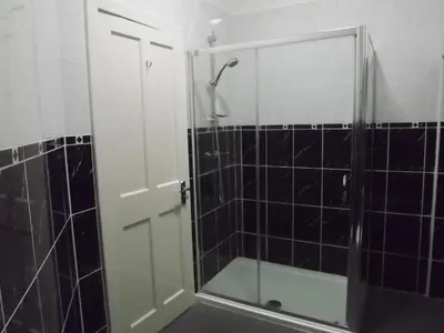 a shower with a glass door in a bathroom at Palace Hotel - Small Hotel in Oban