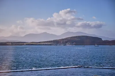 a large body of water with mountains in the background at Muthu Oban Regent Hotel in Oban