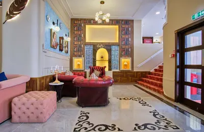 a lobby with red chairs and a staircase at Muthu Oban Regent Hotel in Oban