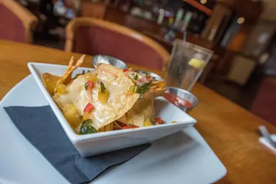 a white plate of food on a wooden table at The Royal Hotel in Oban