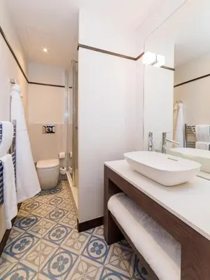 a bathroom with a sink and a toilet at The Perle Oban Hotel & Spa in Oban