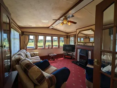 a living room with a couch and a television at The Lambourne 71 in Dunoon