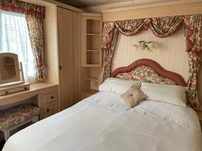 a bedroom with a large white bed in a room at The Lambourne 71 in Dunoon