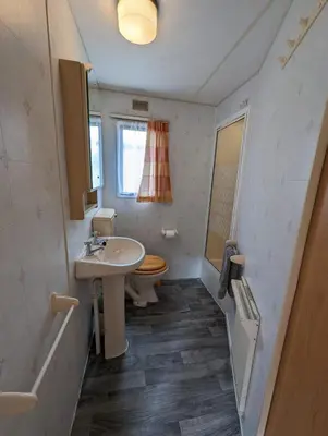 a bathroom with a sink and a toilet at 55 Glenfinart Caravan Park in Dunoon